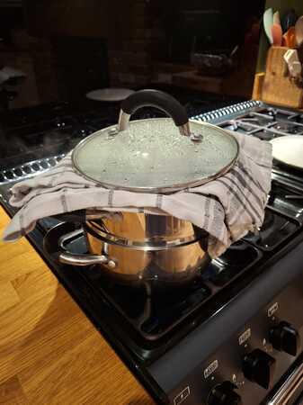 Tea towel over a metal steamer.