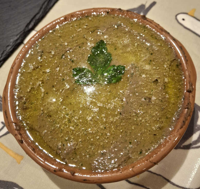 Lamb Liver Pate covered in melted butter.