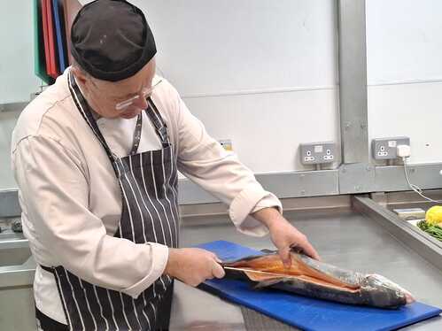 Teacher Paul Filleting the BIG Trout.