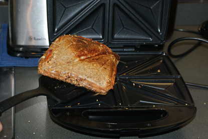 A toastie machine with a sandwich