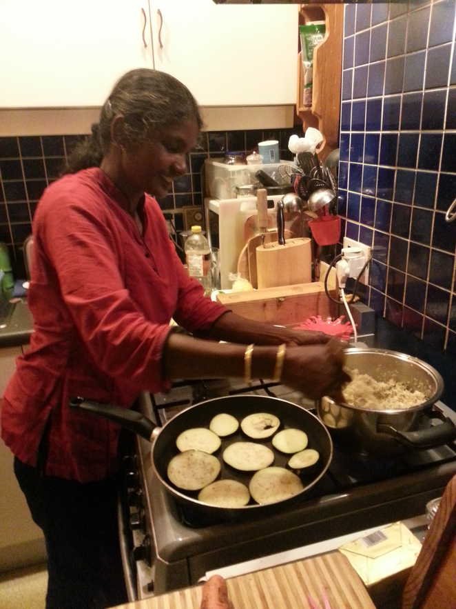 Laly stirs her cabbage.