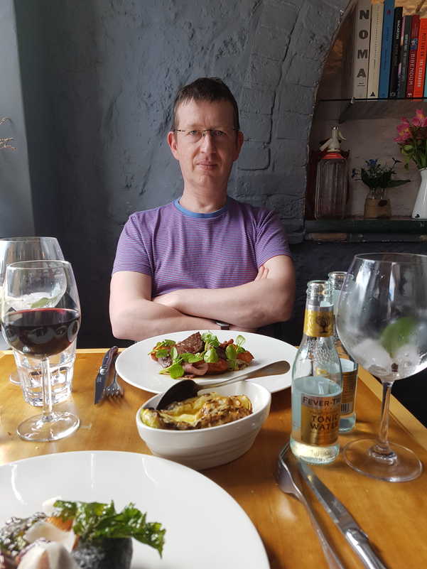 Professor Nick eating Lincoln red beef and drinking Cornish pastis & tonic.