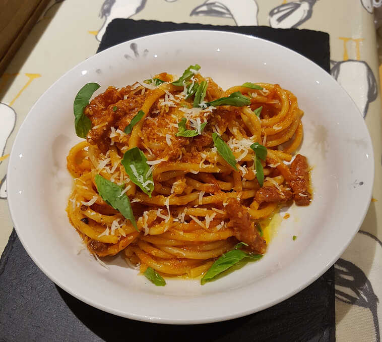 Bucatini all'Amatriciana. Delicately dressed with basil leaves.