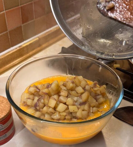 Mixing potato and beaten egg