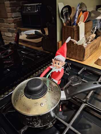 A naughty elf stealing Tom Kha Kai